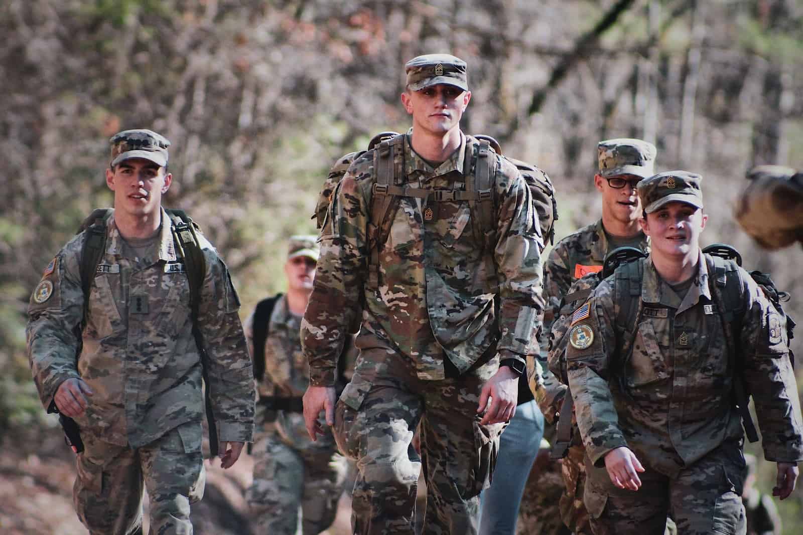 men in camouflage uniform standing on field during daytime