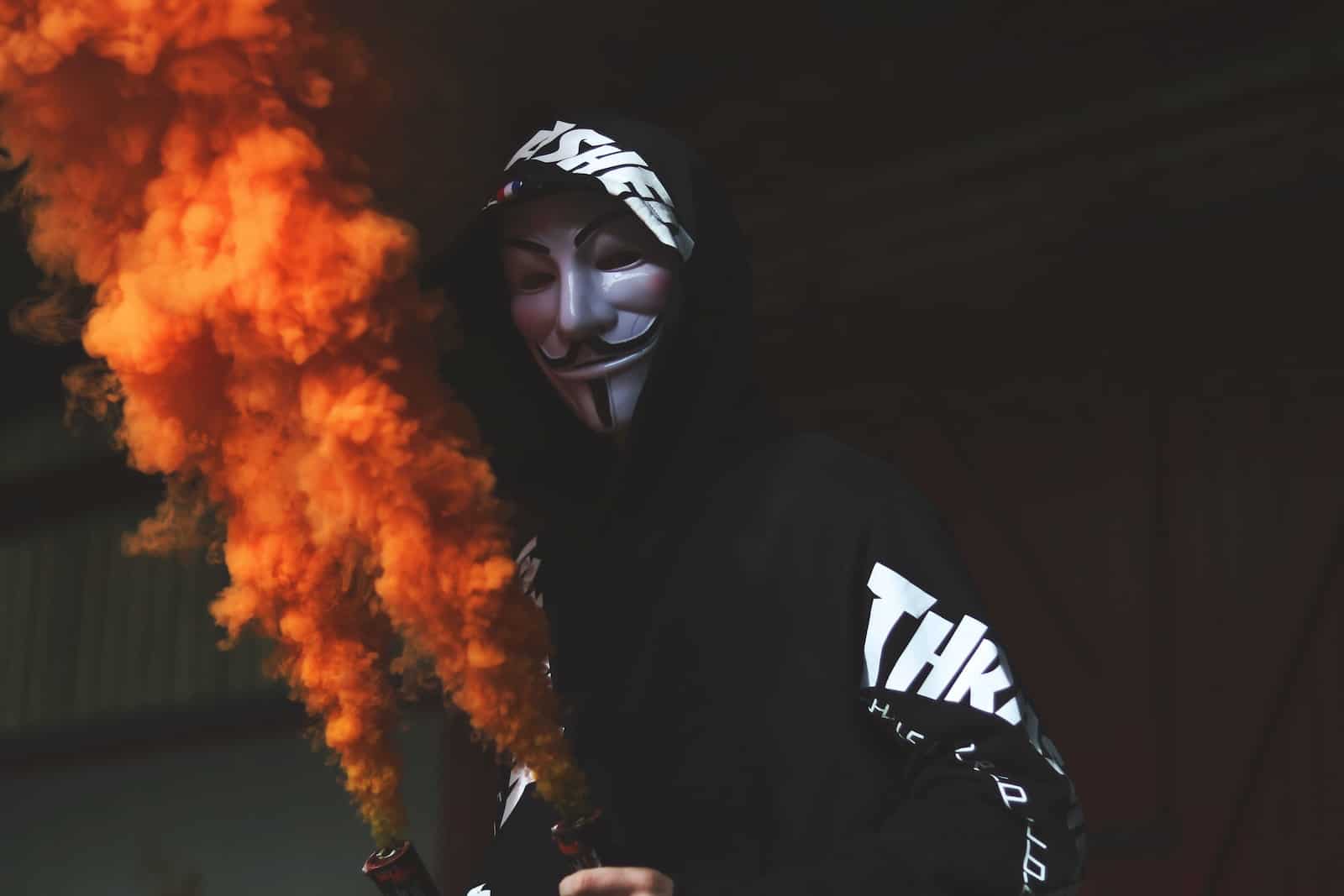 person wearing guy fawkes mask