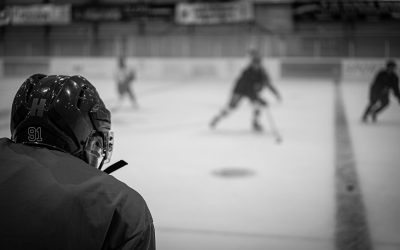 a group of people playing a game of ice hockey