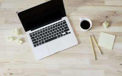 turned off MacBook Pro beside white ceramic mug filled with coffee